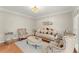 Elegant living room featuring a chandelier, hardwood floors, and sophisticated furniture at 789 Rutland Ct, Lithonia, GA 30058