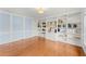 Bright living room featuring hardwood floors and custom built-in bookshelves for ample storage at 789 Rutland Ct, Lithonia, GA 30058