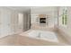 Primary bathroom features a jacuzzi tub and views into the connected primary bedroom at 789 Rutland Ct, Lithonia, GA 30058