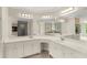 Bright primary bathroom featuring double sinks, white cabinets and tile floors at 789 Rutland Ct, Lithonia, GA 30058