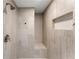 Updated shower featuring elegant tile work, a built-in shower bench, and a recessed soap and shampoo caddy at 789 Rutland Ct, Lithonia, GA 30058