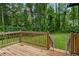 Back deck with a wooden railing and a baby gate, overlooking a large green lawn at 1033 Justice Nw Ln, Acworth, GA 30102