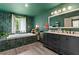A spacious bathroom featuring a soaking tub, tile surround, double vanity and tile flooring at 1033 Justice Nw Ln, Acworth, GA 30102