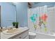 Small bathroom featuring blue walls, a single sink, and a bathtub with a colorful shower curtain at 1033 Justice Nw Ln, Acworth, GA 30102