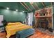 Bedroom featuring hardwood floors, stone fireplace and green walls and ceilings at 1033 Justice Nw Ln, Acworth, GA 30102