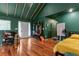 Spacious, high-ceilinged bedroom with hardwood floors and stylish green walls at 1033 Justice Nw Ln, Acworth, GA 30102