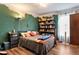 A well-lit bedroom with hardwood floors, a built-in bookcase, and soft, neutral decor at 1033 Justice Nw Ln, Acworth, GA 30102
