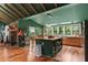 An open-concept kitchen featuring an island, hardwood floors, a stone fireplace and wood beam ceilings at 1033 Justice Nw Ln, Acworth, GA 30102