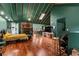 Open-concept living room with hardwood floors, fireplace and green walls and ceiling at 1033 Justice Nw Ln, Acworth, GA 30102
