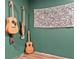 Features four guitars hanging on a green wall, with a decorative tapestry on the wall at 1033 Justice Nw Ln, Acworth, GA 30102