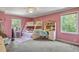 Bedroom with pink walls, bunk beds, a study desk, and two windows providing natural light at 2190 Stephen Long Ne Dr, Atlanta, GA 30305