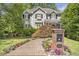 Charming home with lush landscaping, brick walkway, and a well-maintained lawn and surrounding trees at 2190 Stephen Long Ne Dr, Atlanta, GA 30305
