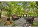 Outdoor fire pit area surrounded by mature trees and comfortable seating on a stone patio at 2190 Stephen Long Ne Dr, Atlanta, GA 30305
