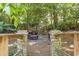 Stone-paved firepit area with cushioned seating and surrounded by lush greenery and mature trees at 2190 Stephen Long Ne Dr, Atlanta, GA 30305