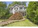 Charming two-story home featuring mature landscaping, a brick walkway, and a covered front porch at 2190 Stephen Long Ne Dr, Atlanta, GA 30305