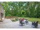 Large backyard featuring a deck, patio, mature trees, and ample seating at 225 River Springs Dr, Sandy Springs, GA 30328