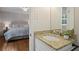 Bathroom with granite counters, mirror, and view to the main bedroom at 225 River Springs Dr, Sandy Springs, GA 30328