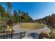 Community green space with a paved walkway, mature trees, and meticulously maintained landscaping, perfect for outdoor enjoyment at 225 River Springs Dr, Sandy Springs, GA 30328