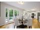 Cozy dining area next to an open kitchen, featuring hardwood floors and a view of the private backyard at 225 River Springs Dr, Sandy Springs, GA 30328