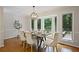 Elegant dining room featuring hardwood floors, modern lighting, and picturesque views of the backyard at 225 River Springs Dr, Sandy Springs, GA 30328
