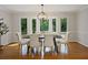 Charming dining area with hardwood floors, stylish lighting, and serene views of the surrounding greenery at 225 River Springs Dr, Sandy Springs, GA 30328