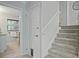 Hallway with carpeted stairs, white trim, and a partial view of the bathroom at 225 River Springs Dr, Sandy Springs, GA 30328