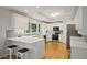 Bright white kitchen boasts stainless appliances, sleek countertops and hardwood floors at 225 River Springs Dr, Sandy Springs, GA 30328