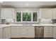 Updated kitchen features stainless steel appliances, granite countertops and a window overlooking the yard at 225 River Springs Dr, Sandy Springs, GA 30328