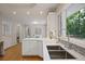 Bright kitchen with stainless sink under the window looking out to the green backyard at 225 River Springs Dr, Sandy Springs, GA 30328