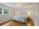 The main bedroom has hardwood floors, a ceiling fan, and large windows for natural light at 225 River Springs Dr, Sandy Springs, GA 30328