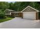 Inviting two-story home with a spacious driveway, attached garage, and well-maintained landscaping at 225 River Springs Nw Dr, Sandy Springs, GA 30328