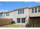 A cozy backyard with a small patio space, lawn, and privacy fence at 129 Finsbury Ln, Woodstock, GA 30188