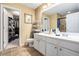 The bathroom features a double sink vanity and an open door to the walk-in closet at 129 Finsbury Ln, Woodstock, GA 30188