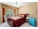 This bedroom has a ceiling fan and a large window allowing lots of natural light at 129 Finsbury Ln, Woodstock, GA 30188