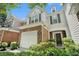 Charming home featuring stone accents, a two-car garage, and well-maintained landscaping at 129 Finsbury Ln, Woodstock, GA 30188