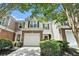 Charming home featuring stone accents, a two-car garage, and well-maintained landscaping at 129 Finsbury Ln, Woodstock, GA 30188