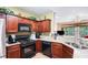 Well-equipped kitchen with granite countertops, stainless steel appliances, and ample cabinet space at 129 Finsbury Ln, Woodstock, GA 30188