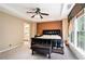 This is a spacious main bedroom with a decorative ceiling fan and a large window at 129 Finsbury Ln, Woodstock, GA 30188