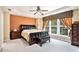 This main bedroom offers a ceiling fan and three large windows allowing lots of natural light at 129 Finsbury Ln, Woodstock, GA 30188