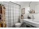 Clean bathroom featuring a sink, toilet, shower with curtain, and a shelf at 19 Hilliard Se St # 13, Atlanta, GA 30312
