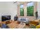 Cozy living room with hardwood floors, comfortable seating, and large windows with views of surrounding greenery at 19 Hilliard Se St # 13, Atlanta, GA 30312
