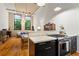 Sun-filled living room showcases high ceilings, an open design, and a modern kitchen setup with sleek appliances at 19 Hilliard Se St # 13, Atlanta, GA 30312