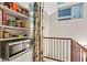 A white pantry with shelves and a microwave next to a staircase with a wooden railing at 19 Hilliard Se St # 13, Atlanta, GA 30312
