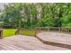Wooden back deck area overlooks a green and treed area at 214 Jamestown Ave, Jonesboro, GA 30236