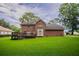 Expansive backyard view of brick home featuring a deck and lush green lawn at 214 Jamestown Ave, Jonesboro, GA 30236