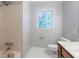 Neutral bathroom with tiled floor, shower, toilet, and window providing natural light at 214 Jamestown Ave, Jonesboro, GA 30236