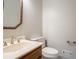 A functional half bathroom features a vanity and toilet at 214 Jamestown Ave, Jonesboro, GA 30236