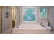 This renovated bathroom has a soaking tub and a glass encased shower with gold hardware at 214 Jamestown Ave, Jonesboro, GA 30236