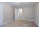 A simple bedroom features neutral paint, carpet, and one window at 214 Jamestown Ave, Jonesboro, GA 30236