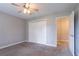 This carpeted bedroom features a ceiling fan, closet, and access to an adjacent room at 214 Jamestown Ave, Jonesboro, GA 30236